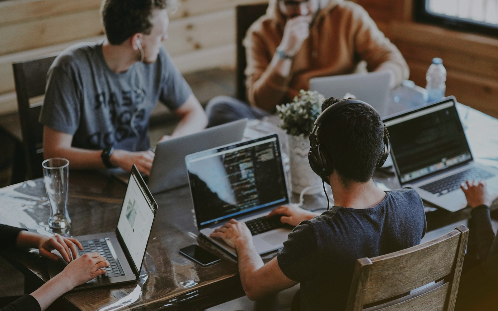 A diverse web design team working together on laptops