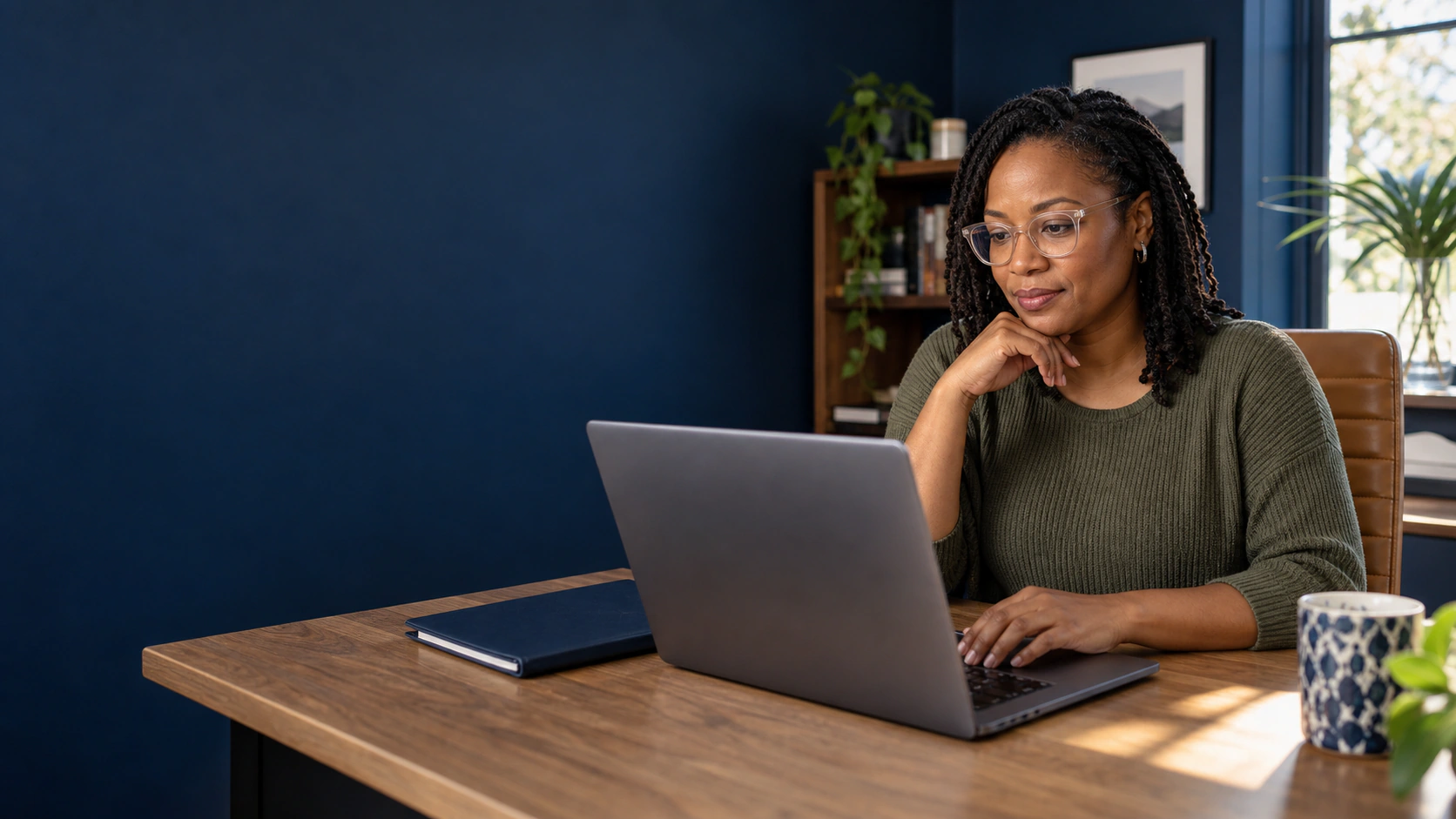 Illustrative scene of a professional carefully reviewing information on her laptop