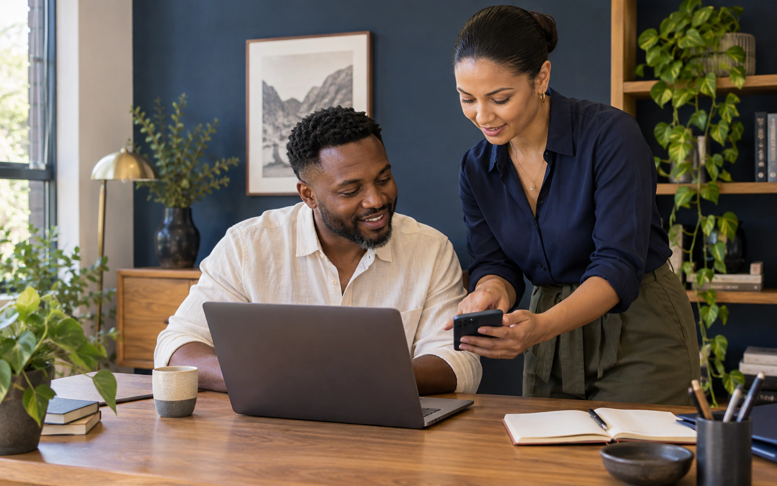 Illustrative scene of two colleagues setting up business email on a laptop and phone